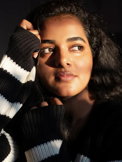 A beautiful golden hour portrait of a makeup artist. The warm light hitting her face highlights her features and creates a soft, glowing effect.