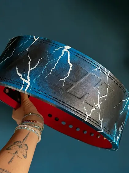 Even a gym accessory can be art. I painted this cool blue lightning design on a leather weightlifting belt.