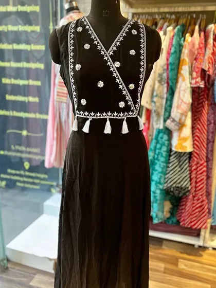 A custom embroidered black kurta with a stylish wrap-around design and tassel details. It's a chic and modern take on the classic kurta.