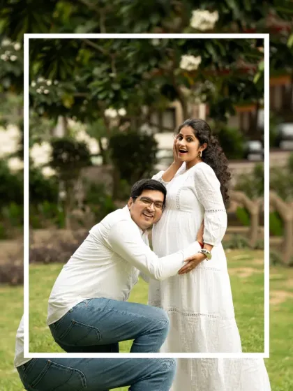 A classic and sweet pose for an outdoor maternity shoot. The father-to-be lovingly listens to the baby bump, surrounded by the greenery of a park.