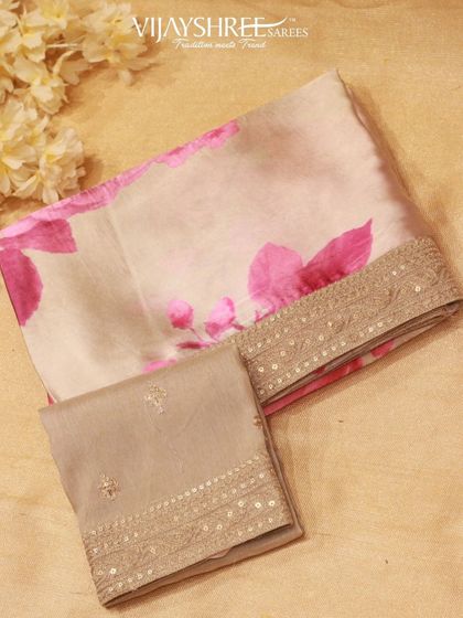 A delicate organza saree with a floral print and a sequined border, perfect for a cocktail evening.