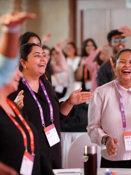 Beyond the stage, we focus on the human element. This candid shot captures the genuine laughter and enjoyment of attendees during a conference session, highlighting our skill in documenting the authentic atmosphere of an event.