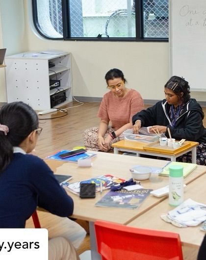 A group of educators at Kai Early Years engaged in a practical life activity. Our workshops emphasize the importance of these foundational exercises for developing a child's independence and fine motor skills.