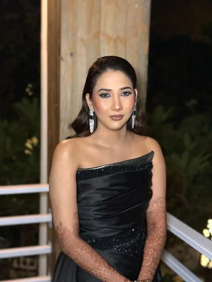 A portrait of my client looking like a bomb for her cocktail party in a black off-shoulder dress. The makeup is sultry and glamorous, perfect for a night of dancing.