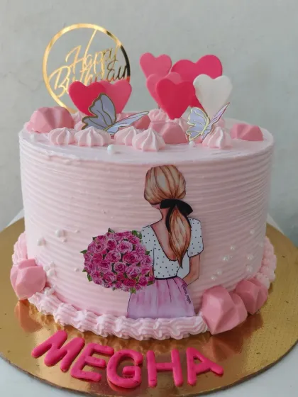 A pretty pink birthday cake for a girl, featuring a fashion illustration topper and pink chocolate hearts.