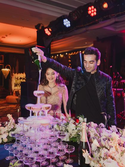 The moment the celebration officially began. A grand champagne tower pour is a classic way to kick off a cocktail night and set a glamorous tone for the evening.