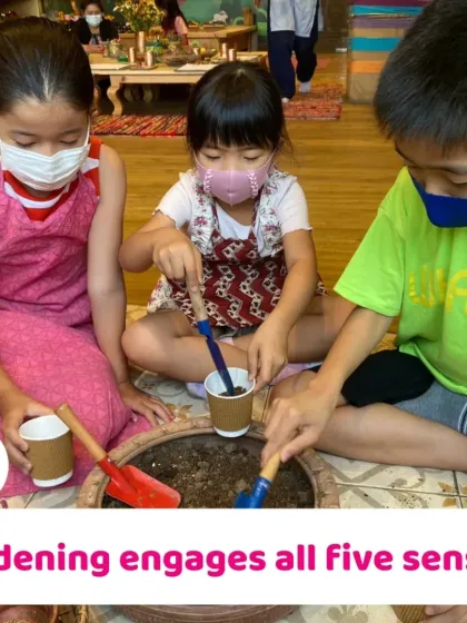 Gardening engages all five senses, from the feeling of the soil to the smell of the plants. Here, children are scooping soil, a fundamental step in their planting journey.