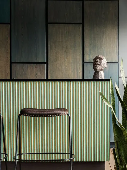 Details are everything. This bespoke bar showcases our passion for craftsmanship, combining a fluted mint green facade with stained teak wood and matte black accents for a striking, artful, and functional centerpiece.