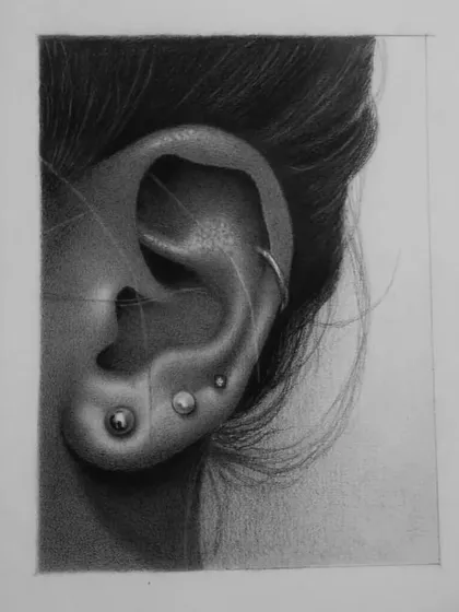 The work-in-progress of a student's ear drawing, with the initial line art still visible.