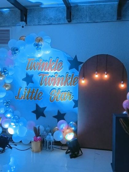 An alternate angle of the "Twinkle Twinkle" setup, highlighting the warm glow of the hanging Edison bulbs next to the cool blue of the main backdrop. This shows how we use different lighting elements to create mood.
