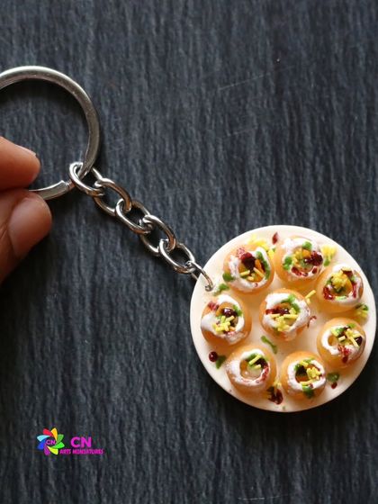 A dahi puri keychain, capturing the delicious chaos of this popular street food snack.