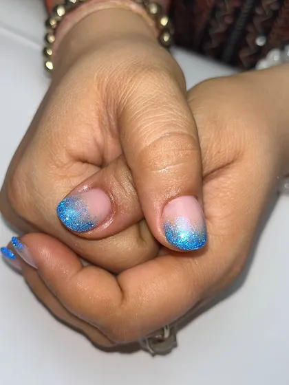 This pose shows off the sparkling blue glitter tips, a perfect look for a party or a beach holiday.