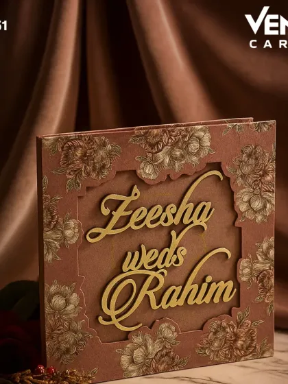This invitation makes a statement with its bold, laser-cut frame featuring intricate floral details. The large, flowing script of the couple's names in gold becomes the central design element, creating a look of modern, artistic elegance.