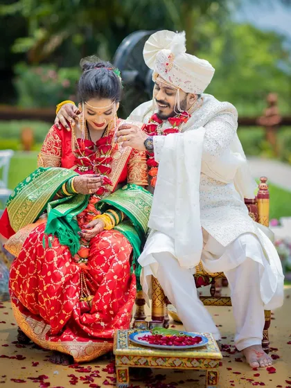 A candid, happy moment between the couple as they sit together during their wedding ceremony.