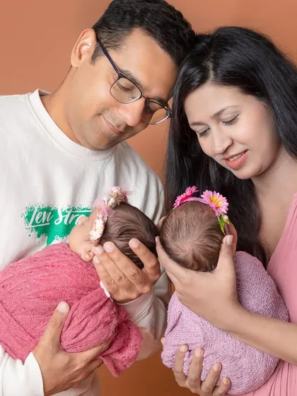 A tender moment as parents gaze lovingly at their newborn twins. These are the quiet, emotional moments I aim to preserve.