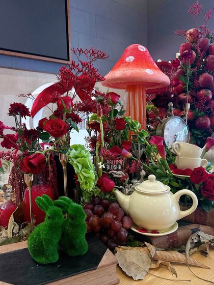 A detailed shot of the centerpiece, featuring mossy green rabbits and a teapot.