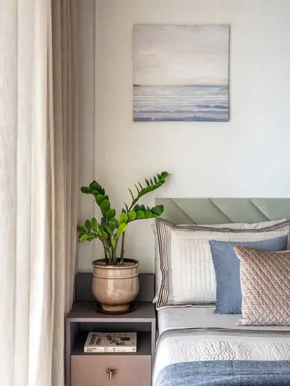 A detail of the parents' bedroom, showcasing the soothing color combination and the peaceful artwork that complements the space.
