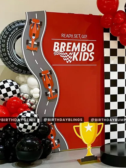 A close-up of the "Brembo Kids" race car theme, showing the custom-designed backdrop with a winding racetrack.