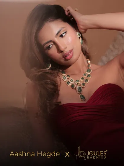 Luxury and poise personified. Influencer Aashna Hegde looks stunning in our Mehrani emerald necklace set, paired with a deep red gown for a glamorous evening look.