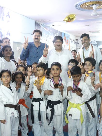 A group of our victorious students with their medals and trophies, celebrating together after a successful tournament.