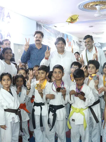 A group of our victorious students with their medals and trophies, celebrating together after a successful tournament.