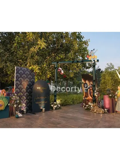 The main entrance setup for the Vrindavan party, with various props and statues creating an immersive experience.