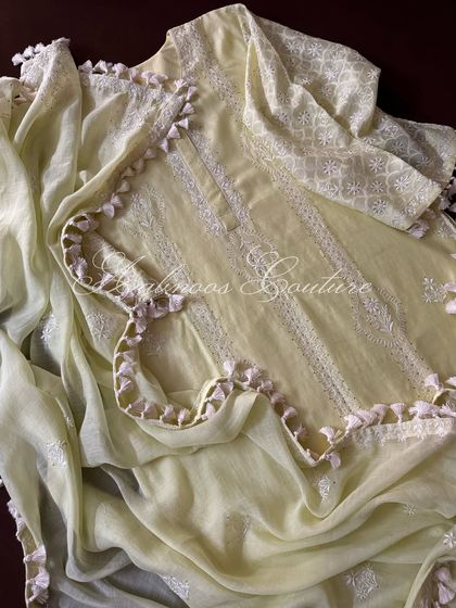 An artistic shot of the kurta and dupatta, highlighting the scalloped, tassel-finished edges.