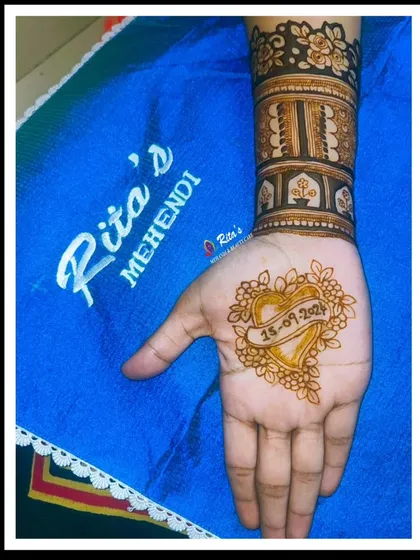 A simple yet beautiful engagement design, with the date of the ceremony highlighted in a heart on the palm.