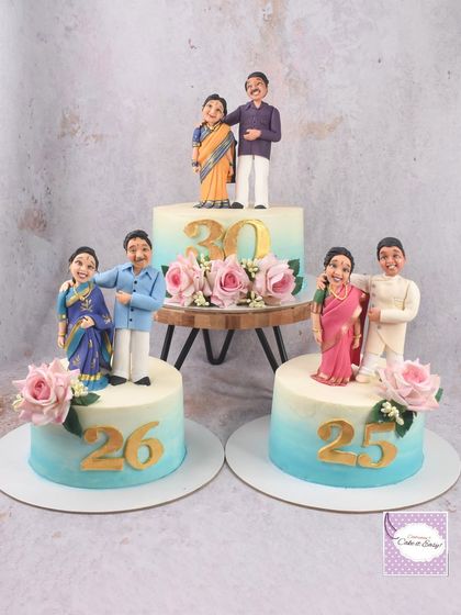 The full trio of anniversary cakes, celebrating 25, 26, and 30 years together. It was a lovely idea to give each couple their own cake with a keepsake figurine.
