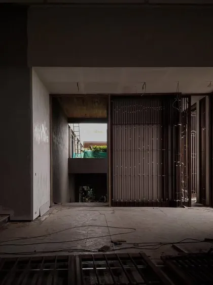 The interior of Villa Toshi during construction. The play of light and shadow through the slatted screens hints at the dramatic, atmospheric spaces that will emerge once the project is complete.