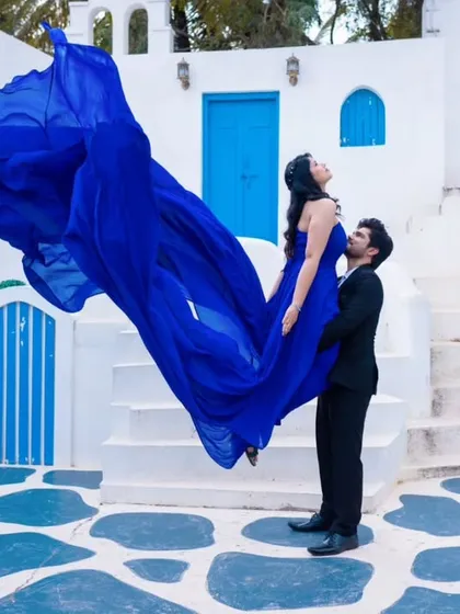 Create a magical moment with this royal blue flying gown, perfect for pre-wedding photoshoots. The lightweight trail catches the wind beautifully, making you feel like you're floating.