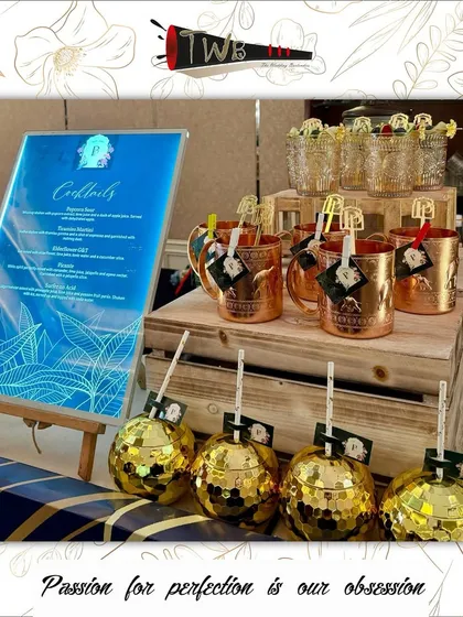 A stylish bar setup for an engagement party, featuring a custom backlit menu and personalized glassware that elevates the guest experience.