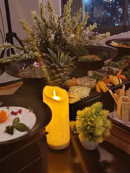 The city lights in the background add to the magic of this candlelit buffet, complete with flowers and our most delicious dishes.