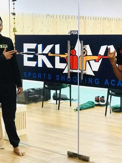 Visiting shooters posing in front of the Eklavya logo, a testament to our growing community and reputation as a top training center.