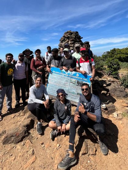 Our group at the Pushpagiri peak marker on the Kumara Parvatha trail. It's a tough climb, and reaching this point is a huge milestone.