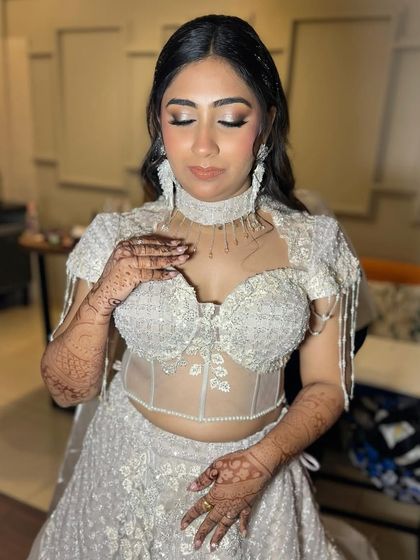 Even with eyes closed, the glamour shines through. This shot highlights the intricate eyeshadow blending and the shimmering details that make this look perfect for an evening event.