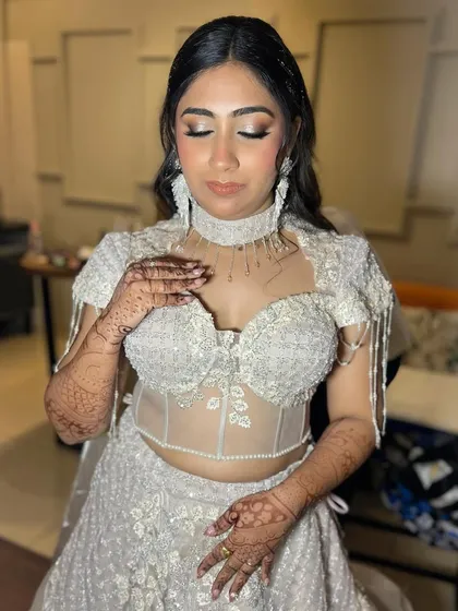 Even with eyes closed, the glamour shines through. This shot highlights the intricate eyeshadow blending and the shimmering details that make this look perfect for an evening event.