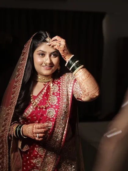 A final touch-up in the mirror. The bride looks confident and beautiful, ready for her reception.