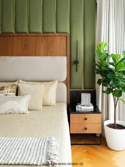 A closer look at the details in this serene bedroom. The fiddle leaf fig plant and warm wood tones create a connection to nature, enhancing the room's calming atmosphere.