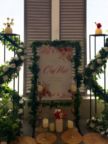 Welcome home. For this housewarming, we created a warm and inviting entrance with a personalized sign framed by fresh greenery and white roses. It's these little details that make a new house feel like a nest.