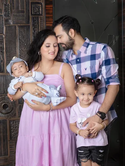 A loving family portrait, full of warmth and connection. The parents' joy is so evident.