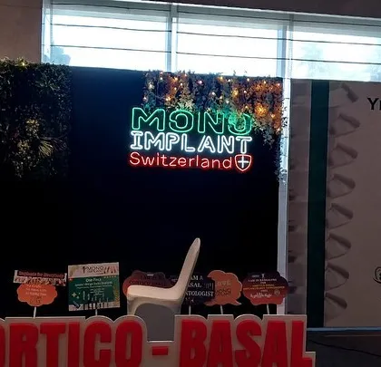 For this corporate event, I created a branded backdrop featuring a custom neon sign for "Mono Implant Switzerland". The sign is mounted on a dark, textured panel with subtle lighting to make the brand name stand out.