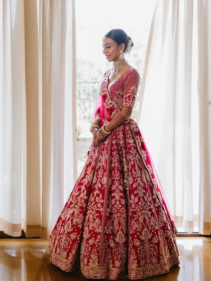 A serene portrait of the bride by the window. The soft, natural light is perfect for showing off the flawless, skin-like finish of the makeup.