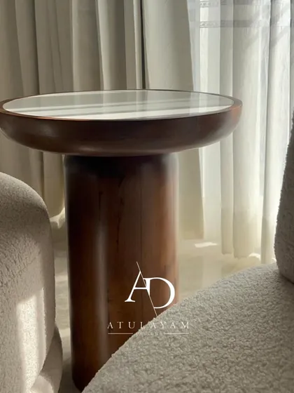 A unique, custom-made side table crafted from rubberwood with a stone top. Its cylindrical base and matte PU finish give it a premium, modern look that stands out from standard furniture.