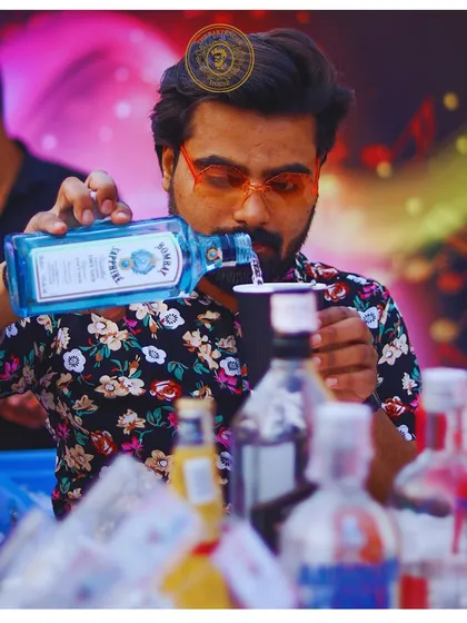 Pouring a classic Bombay Sapphire gin, I am focused on getting the measurement just right. Every great cocktail starts with a perfect pour.