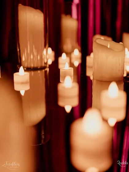 A close-up of floating candles on a mirrored surface, a simple detail that creates a beautiful, reflective effect and adds to the romantic ambiance.