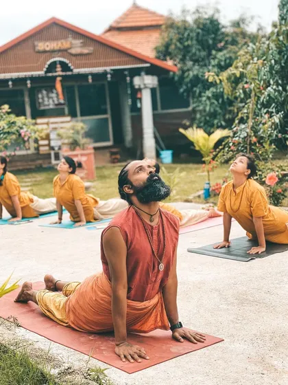 We take our practice into the embrace of nature whenever we can. Here, I am leading a class in Virabhadrasana I (Warrior I Pose) in the ashram garden. Practicing outdoors reminds us that we are part of something larger than ourselves, grounding our energy and strengthening our spirit.
