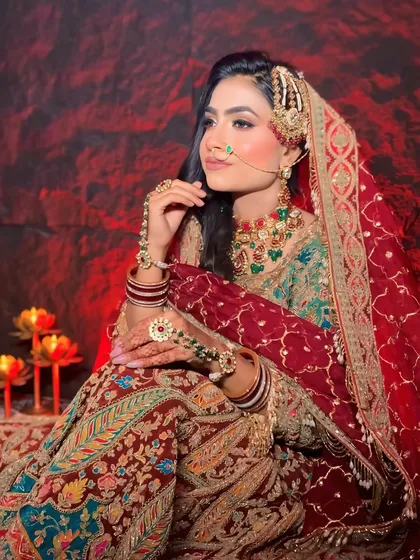 A close-up of a traditional bridal look. We focus on every detail, from the makeup that enhances features to the hairstyling that complements the entire ensemble, including the passa and nose ring.