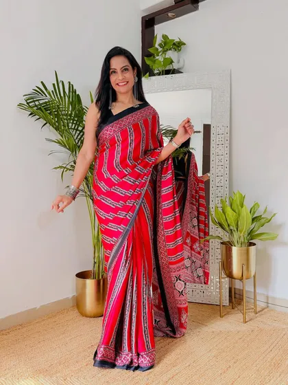 A closer look at this vibrant red satin saree with a modern striped pattern. It's a bold and chic option for parties, and it's under 800 rupees.