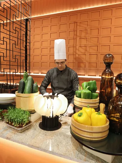 A fresh vegetable station, where our chef prepares salads and other healthy options, showcasing the quality and freshness of our produce.